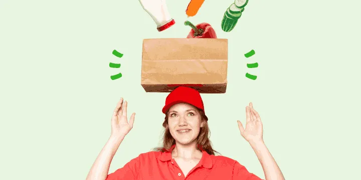 Smiling woman in a red cap balances a paper bag as groceries fall into it