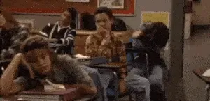 Bored students slump at their desks, one girl resting her head on her hand