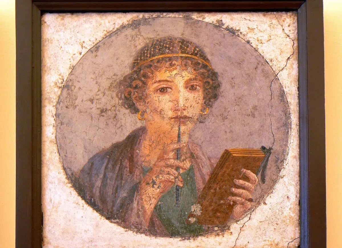 A Roman fresco of a young woman holding a stylus and an open wax tablet
